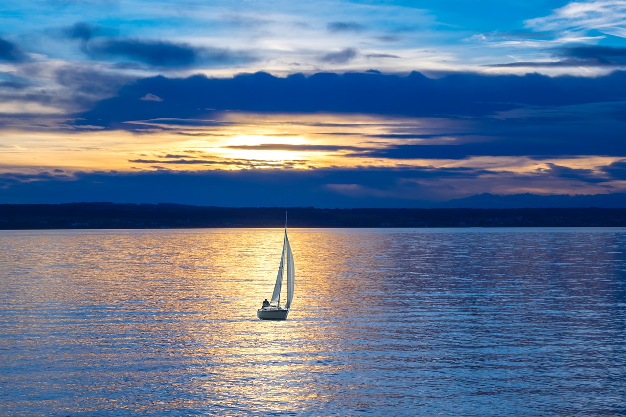 sailboat in open water at sunset