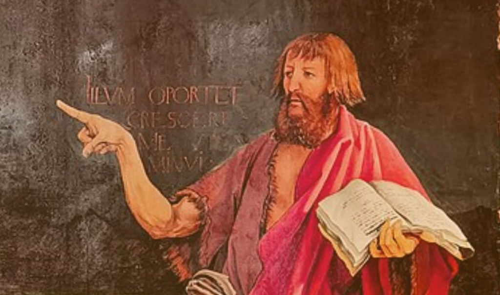 Man holding a book and pointing to the left